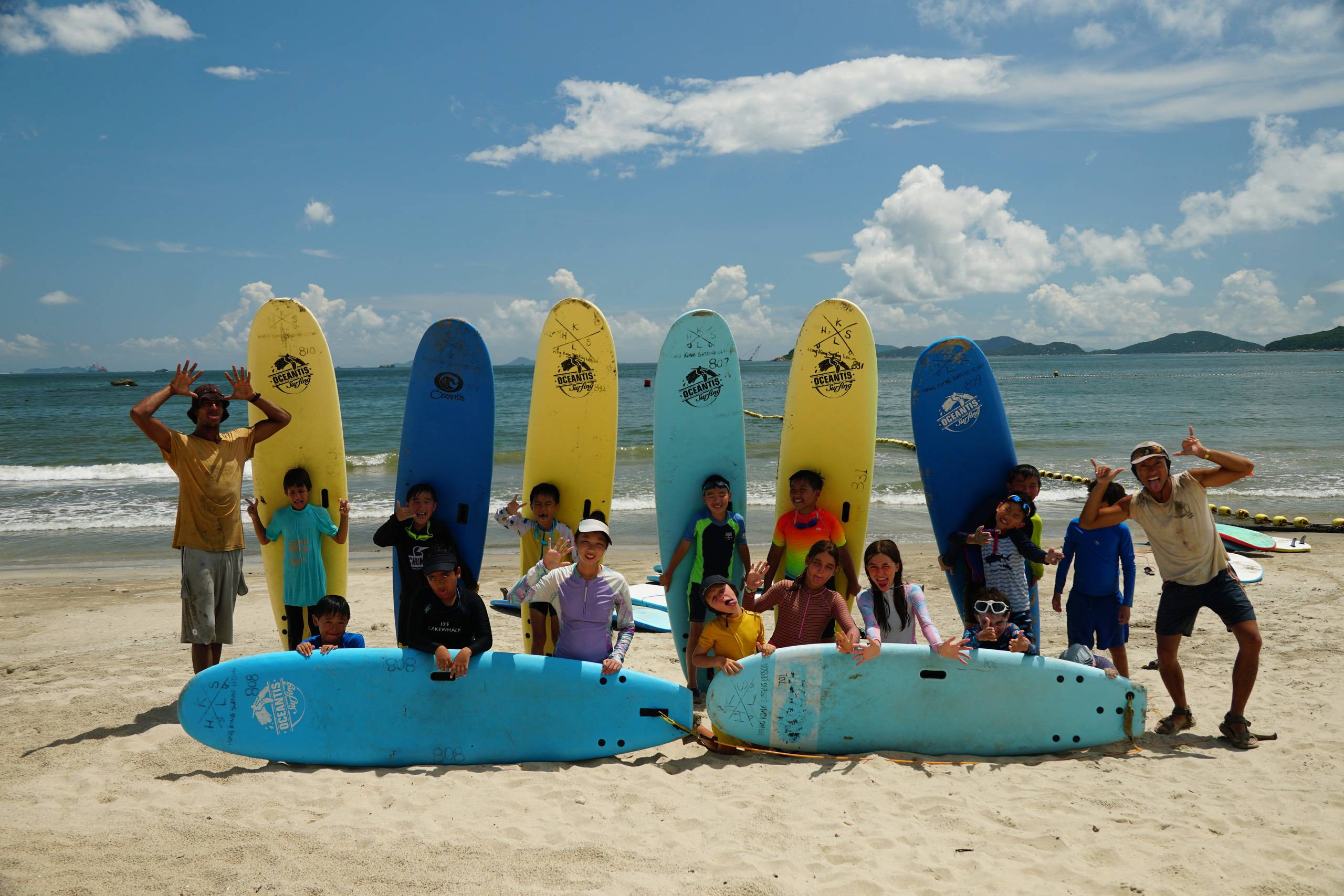 Surfkids Camp group with coaches and surfboards on Lower Cheung Sha Beach, Lantau